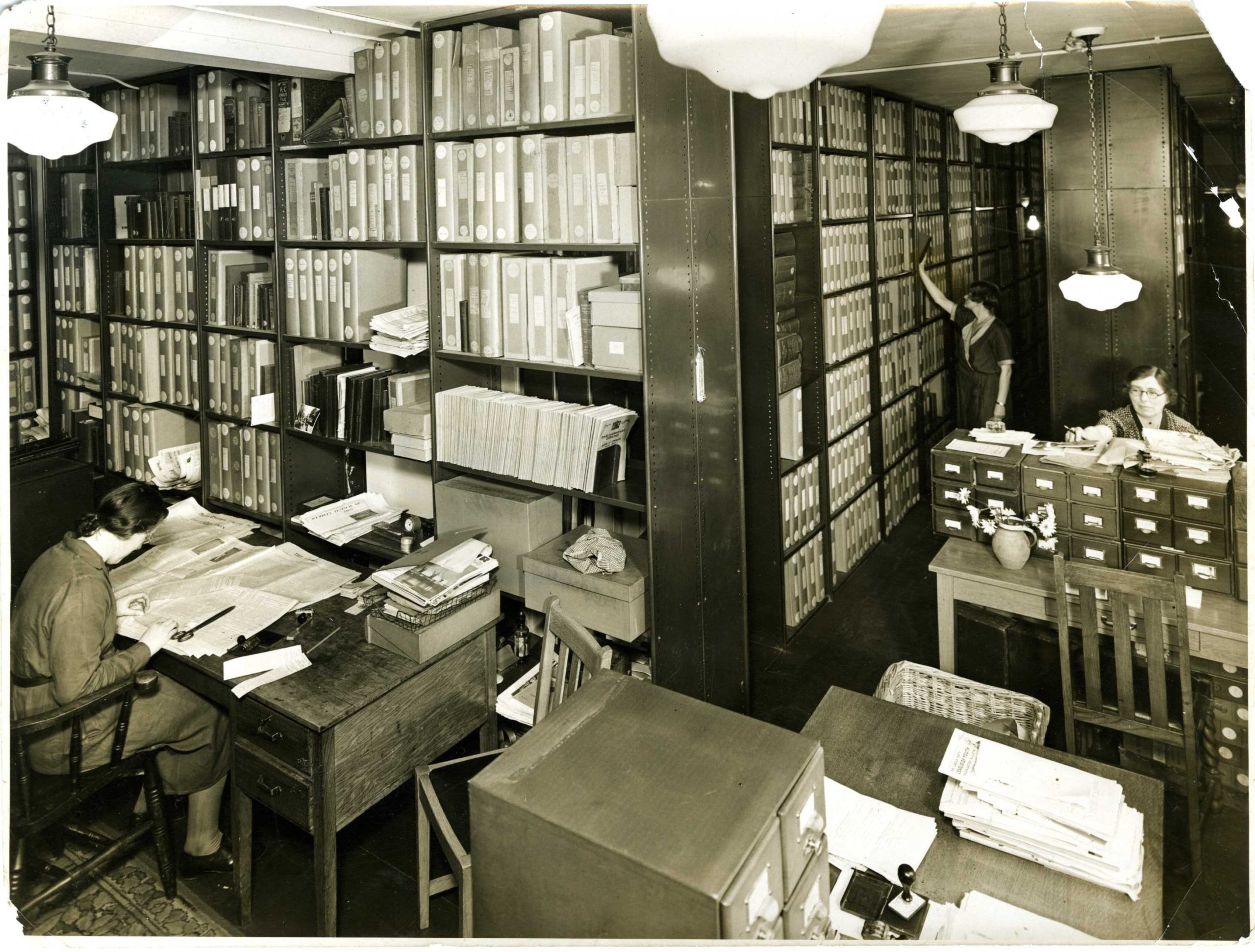 Sepia photo of TUC Library reading room from the 1920s showing card catalogues and pamphlet boxes